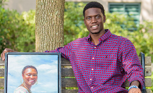 Mr. Chris Singleton with a portrait of his mother, Sharonda Coleman-Singleton, who was one of 9 victims of the Emanuel AME Church shooting on June 17, 2015