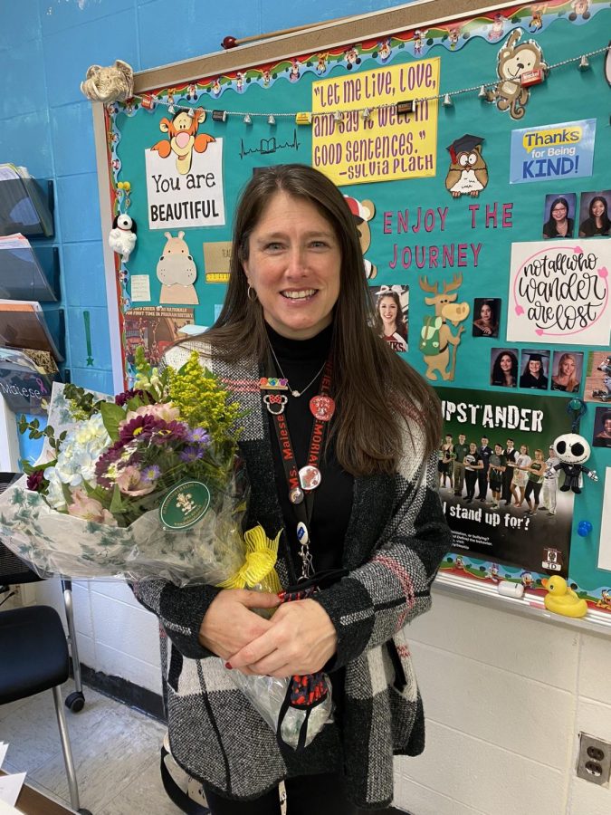 English+teacher+Holly+Maiese+receives+a+bouquet+of+flowers+in+December+2021+for+her+selection+as+HMHS+Teacher+of+the+Year.+